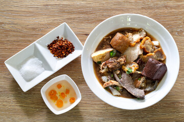 Chinese roll noodle soup with crispy pork, Thai language called *Kuay Jab* and seasoning Chinese food