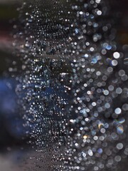 Colorful defocused abstract water droplets in glass with bokeh background