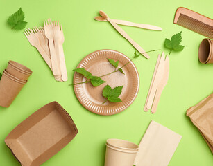disposable paper utensils from brown craft paper and recycled materials on a green background