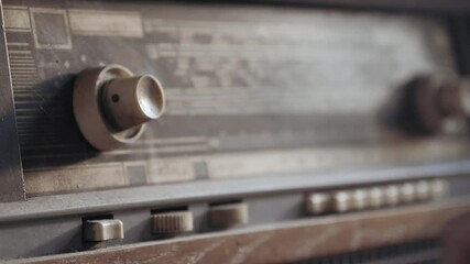 Male hands turning an antiquarian record player on