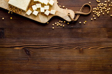 tofu vegan food on cutting board on wooden table top-down copy space