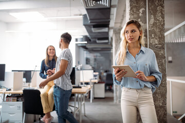 Portrait of a smiling designer, student, freelancer business woman using tablet computer