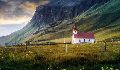 Beautiful natural landscape at sunset. Dramatic evening scenery of Iceland. Amazing small church in mountains valley with colorful sky. Iceland the country of the best Incredible nature locations.