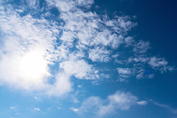 Cirrus clouds in a blue sky, taken on a summer day. the sun shines through a cloud