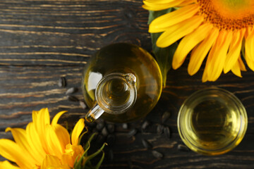 Composition with sunflower, oil and seeds on wooden background