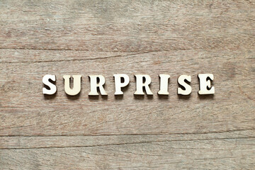 Alphabet letter block in word surprise on wood background