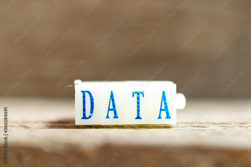 Sticker Letter block with blue color word data on wood background