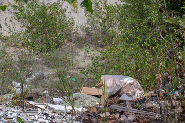 Obraz premium Heaps of dirty garbage rubbish in nature, pollution, plastic. Human influence on the ecology of the planet.