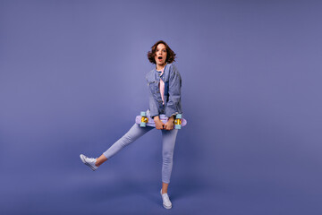 Full-length shot of adorable slim woman in stylish pants. Fashionable brunette girl dancing with...