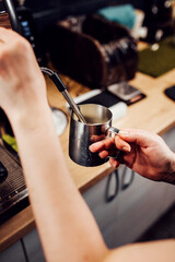 Fototapeta na wymiar Barista hands during work - professional coffee brewing - the art of bartender