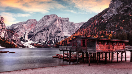 Wonderful sunrise view of Braies lake. Dramatic Unusual Scene. Colorful Sky over lago di Braies in Dolomites Alps. Awesome Alpine Highlands during sunset. Amazing nature Landscape at Autumn Day.