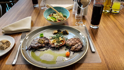 Grilled Ribeye beef Steak with salad and drink on white plate. Food and drink concept