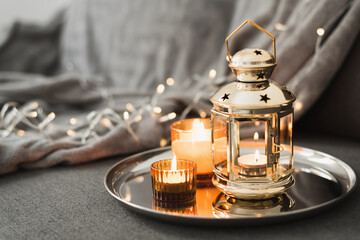 Golden lantern and burning candles on a metal tray. Traditional decor for muslim holidays. Eid Al Adha celebration. Ramadan © VeronikaSmirnaya