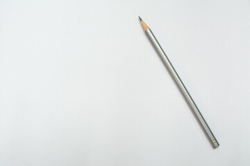 Gray pencil on a white sheet of paper. Place for text.
