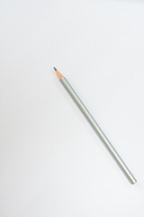 Gray pencil on a white sheet of paper. Place for text.