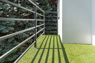 balcony railing with a synthetic grass - Powered by Adobe