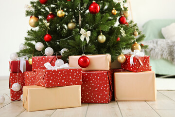 Many gifts under a festively decorated Christmas tree in a bright interior
