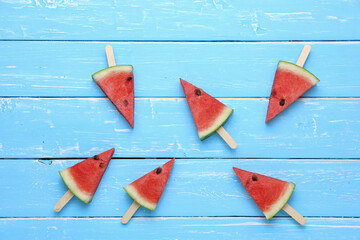 Obraz na płótnie Canvas Watermelon slice fruits on blue wooden table background.