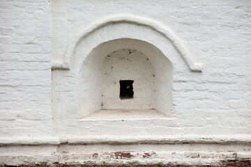 Fragment of the brick wall in ancient traditional Russian kremlin wall with small gun slot window.