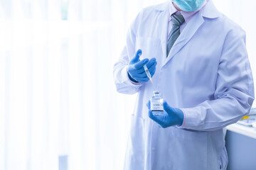 Fototapeta premium Closeup scientist doctor hand using syringe inject vaccine to medical bottle