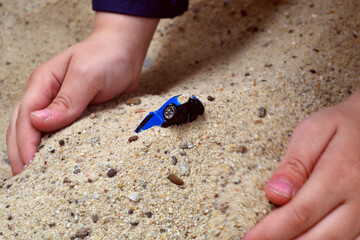 Toy car in sandpit. 