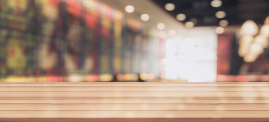 Wooden top table with bokeh light effect and blur restaurant on background