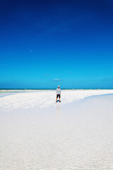 Fototapeta na wymiar Tourist standing on sand bank