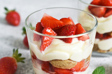 Strawberry tiramisu in a glass on a concrete background. Classic Italian dessert.