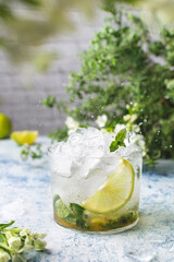 Summer refreshing ice cocktail with lime and mint, mojito or lemonade, copy space