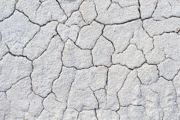 Background cracked, dry white clay, natural material, atmospheric impact, outdoors,