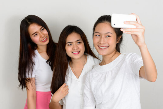 Three Young Beautiful Asian Women As Friends Together