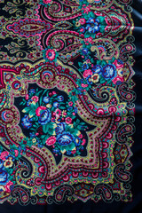 flat lay top view part of floral and paisley pattern on black cotton scarf