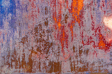 Bright colorful background from rusty metal with old blue and red shabby cracked paint, atmospheric...