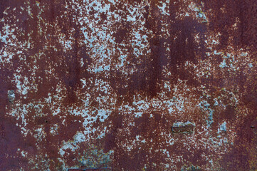 Bright colorful background from rusty metal with old shabby cracked paint, atmospheric impact, outdoors, horizontal photo.
