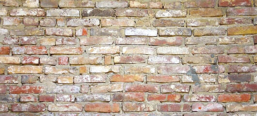 Spotted multicolored dirty brick texture. Grunge rough background
