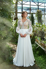 Beautiful woman bride wear in white long wedding dress celebration of love in blossom garden walk...