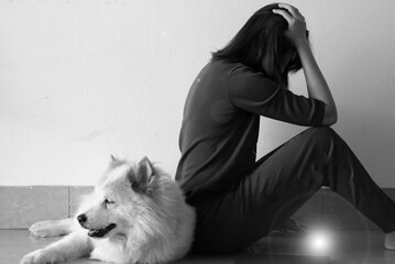Lady sitting beside her dog with unhappy feeling,stress and upset,Lens flare effect,black and white...