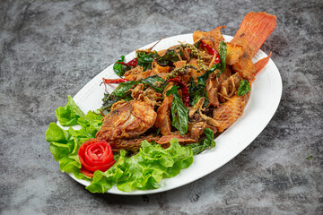 Crispy tilapia fish cooked with herbs, lemongrass, kaffir lime leaves and table sauces.
