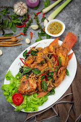 Crispy tilapia fish cooked with herbs, lemongrass, kaffir lime leaves and table sauces.