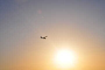 Fototapeta na wymiar Airplane flying over Costa de la Luz into the sun, Cádiz, Spain