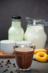 Cocoa served with a delicious chocolate dessert on a black background..