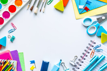 Different colorful stationery for school on white background with copyspace