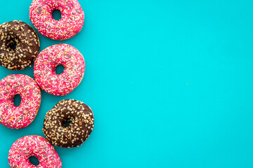 Top view of colorful glazed donut swith sprinkles, copy space