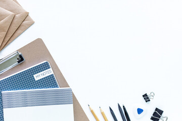 Different stationery for school and office on a white background with copyspace, top view.