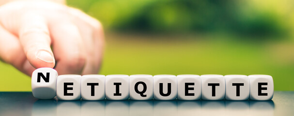 Hand turns dice and changes the word etiquette to netiquette.