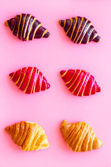 Croissants pattern - set of snacks on pink background