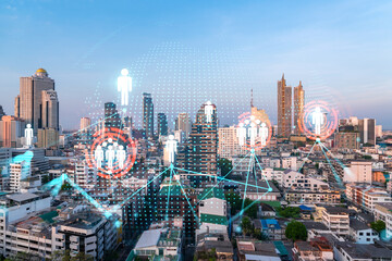 Hologram of social media icons over sunset panoramic cityscape of Bangkok, Asia. The concept of people connections. Multi exposure.