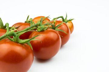 Cherry tomatoes on a branch isolated on a white background.