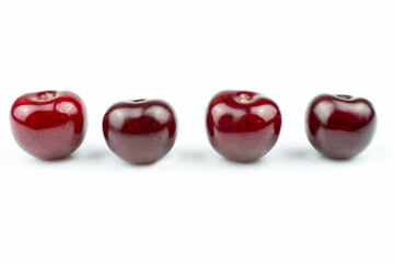 Four sweet cherry fruit close up isolated on white background.