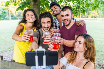 multiethnic group of millennial friends take a selfie celebrating a birthday
